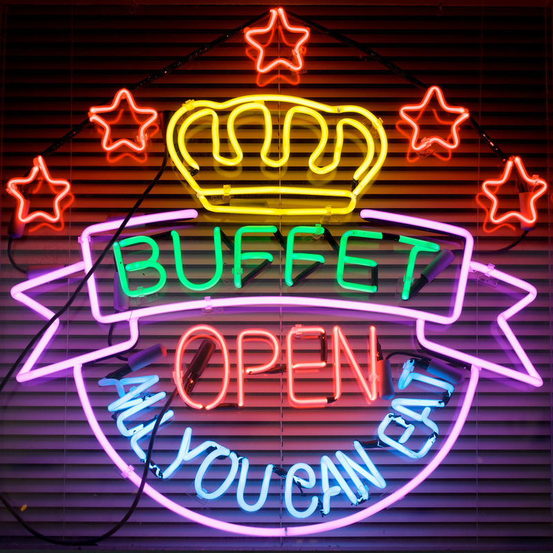 A neon sign advertises an all-you-can-eat buffet.