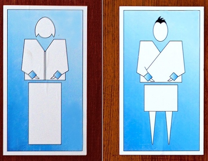Restroom signs from the country of Bhutan display stylized representations of a woman and man dressed in traditional clothing.