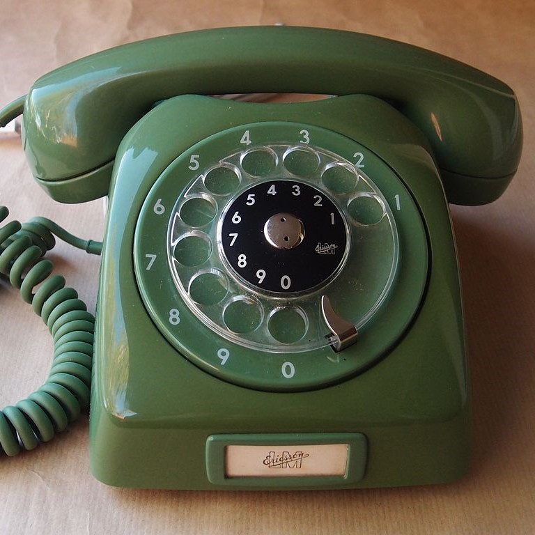 A rotary dial telephone.
