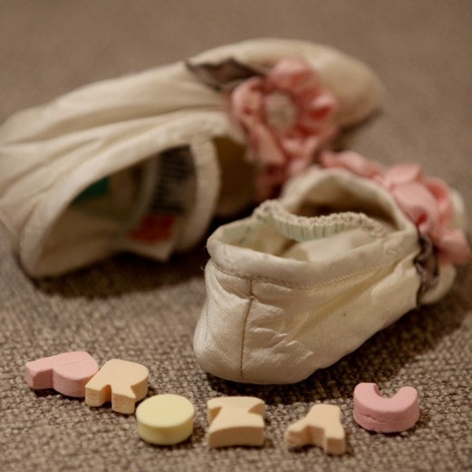 Image of baby booties and the word "Prozac" spelled out in candy letters.